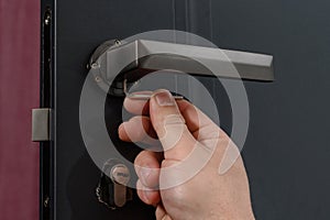 Hex key and installation of door lock and handle, close-up of installation work.