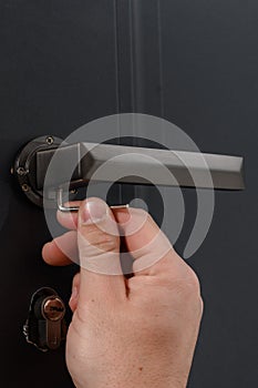 Hex key and installation of door lock and handle, close-up of installation work.