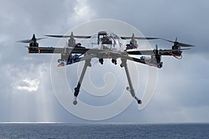 Hexacopter drone flying over the ocean photo
