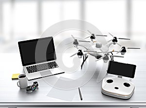 Hexacopter, remote controller, laptop on desk
