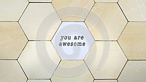 Hexagon missing from puzzle, revealing the words You Are Awesome in a conceptual image of personal growth and optimism
