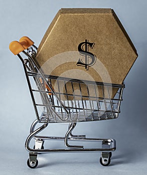 A hexagonal cardboard box inside a shopping trolley.