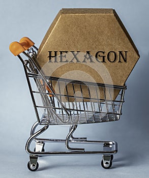 A hexagonal cardboard box inside a shopping trolley.