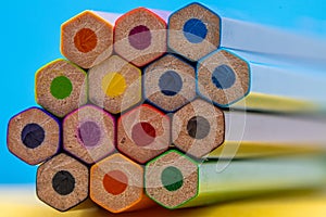 Hexagonal Colored Pencils on Blurred Blue and Yellow Background