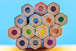 Hexagonal Pattern of Colored Pencils on Blue Background