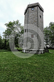 Hexagonal stone outlook tower by woods