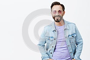 Hey babe, wanna hang out. Portrait of handsome hot adult man with beard and moustache in trendy sunglasses and denim