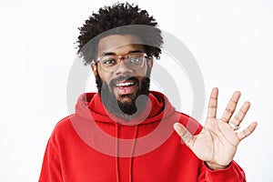 Hey greetings. Portrait of friendly and outgoing sociable african american man getting know new team waving with palm