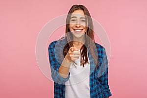 Hey, we need you! Portrait of cheerful pretty girl in checkered shirt with toothy smile pointing to camera