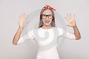 hey, nice to see you. portrait of beautiful emotional young woman in white t-shirt with freckles, black glasses, red lips and