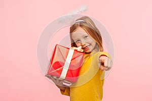 Hey, this present for you! Portrait of happy little ginger girl with angelic halo embracing wrapped box photo