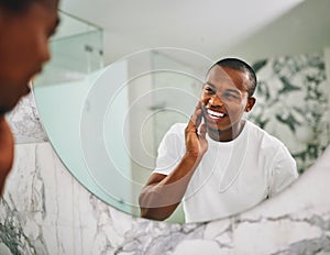 Hey there handsome. Shot of a young man going through his morning routine in the bathroom at home.