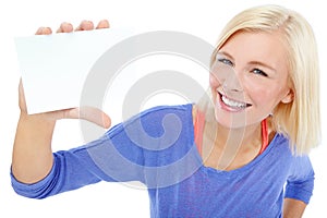 Hey there Use this space ). A beautiful young woman holding a blank card while isolated on a white background.