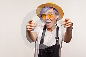 Hey, you are awesome! Portrait of amazed joyful glamour girl pointing to camera with two hands, choosing you. indoor studio shot