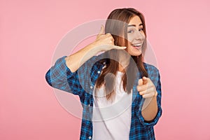 Hey you, call me! Portrait of happy flirtatious beautiful girl smiling playfully and pointing to camera