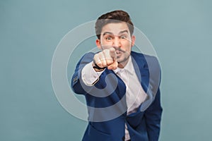 Hey you! Expressive man pointing finger at camera