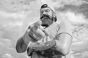 Hey you. Man bearded muscular brutal hipster outdoors sky background. Masculinity and brutality. Lumbersexual tattooed