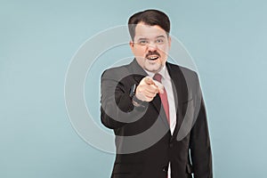 Hey you! Man in suit pointing finger at camera