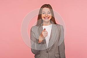 Hey you! Portrait of happy optimistic young woman in business suit making choice with indicating finger