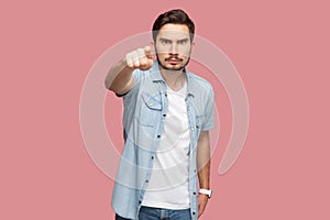 Hey you. Portrait of serious handsome bearded young man in blue casual style shirt standing pointing and looking at camera with