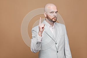 Hey you. Portrait of serious handsome middle aged bald bearded b