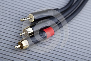 Hi-Fi RCA gold audio cable on grey background