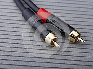 Hi-Fi RCA gold audio cable on grey background
