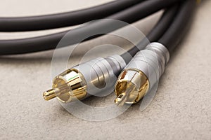 Hi-Fi RCA gold audio cable on paper background