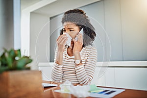 Hi, I need to see the doctor please. a young woman blowing her nose while working at home.