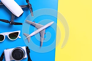 Hi tech travel gadget accessories on blue and pink yellow copy space