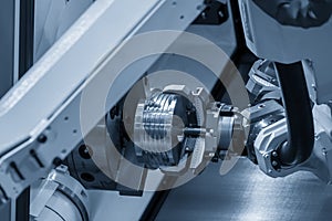 The hi-technology CNC lathe machine operation with gripping robotic system.