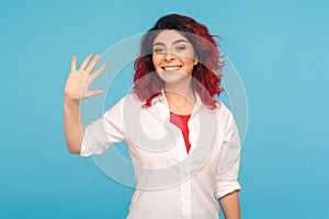 Hi, welcome! Portrait of happy friendly hipster woman with fancy red hair gesturing hello and smiling to camera