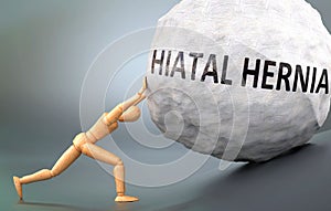 Hiatal hernia and painful human condition, pictured as a wooden human figure pushing heavy weight to show how hard it can be to photo