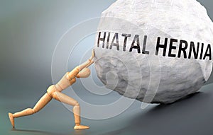 Hiatal hernia and painful human condition, pictured as a wooden human figure pushing heavy weight to show how hard it can be to