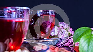 Hibiscus Red tea mug with carnation flowers close-up horizontal photo.English tea tradition.Medicinal therapy based on medicinal