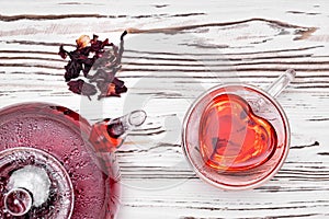 Hibiscus tea in glass teapot and cup