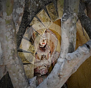 Hidden balinese spiritual wooden statue in a niche