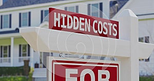 Hidden costs for sale real estate sign with a new home in the background.