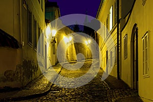 Hidden fairytale street in Prague Novy Svet quarter enlightened by street lamps during night