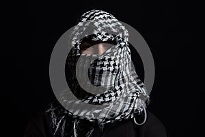 Hidden man with palestinian scarf over head in front of isolated