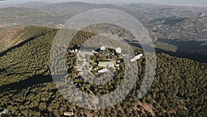 Hidden military science station in high mountain. Aerial view of meteorological radar observatory