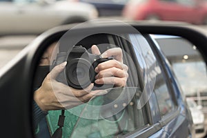 Hidden photographing. Reflection in car mirror