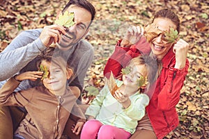 Hide with fall leaves and get poses to camera. Family time.