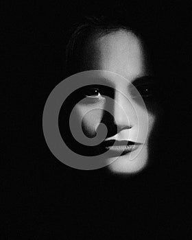 Hiden in the shadows. Horror movie style female portrait photo