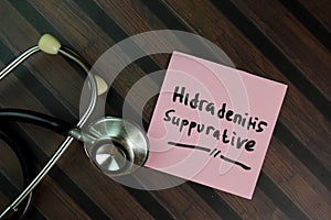 Hidradenitis Suppurative write on sticky notes isolated on Wooden Table