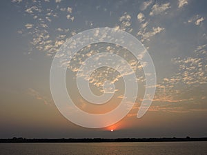 Hidrovia Paraguay ParanÃÂ¡ rayos sol entre las nubes. Sunset at de water way Paraguay Parana photo