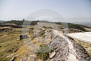 Hierapolis, Turkey. Archaeological Zone. The base channel water system of petrified clay. Right - travertine