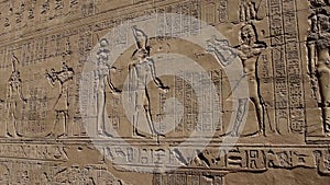 Hieroglyphic carvings on an ancient egyptian temple wall