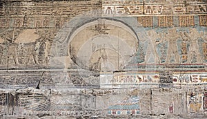 Hieroglyphic carvings on an ancient egyptian temple wall