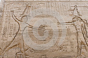 Hieroglyphic carvings on an ancient egyptian temple wall